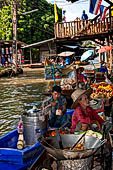 Thailand, Locals sell fruits, food and products at Damnoen Saduak floating market near Bangkok 